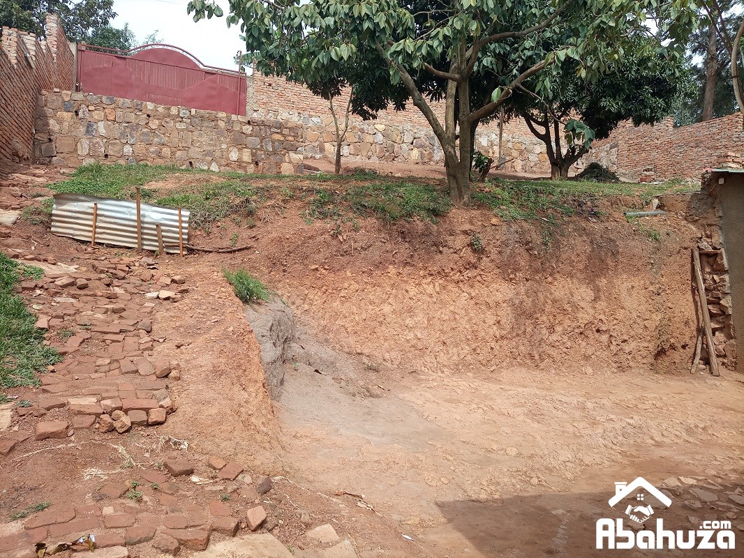 A FENCED PLOT WITH HOUSE FOR SALE IN KIGALI AT REBERO